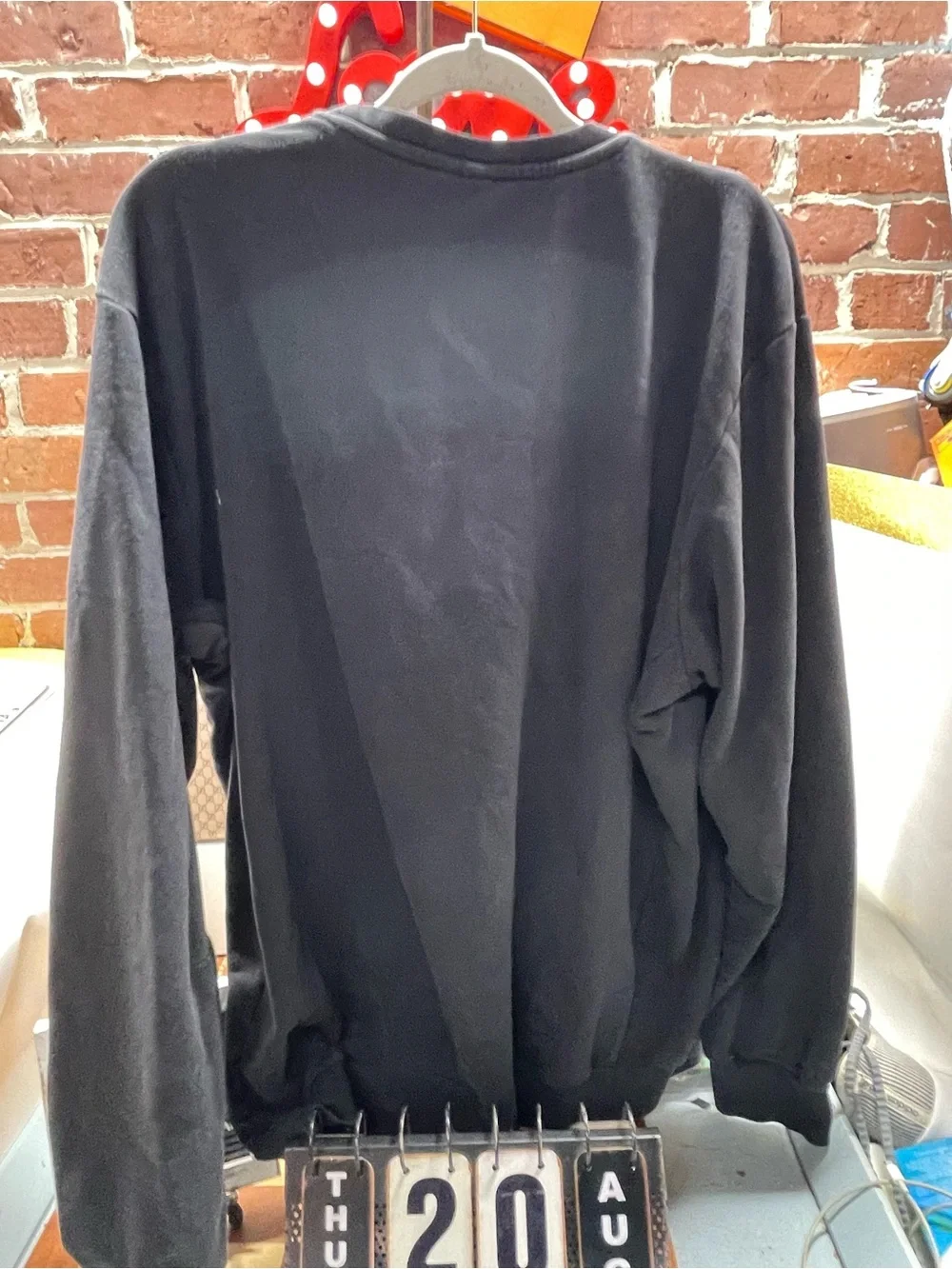 black Adidas crewneck fleece sweatshirt featuring a large white performance
